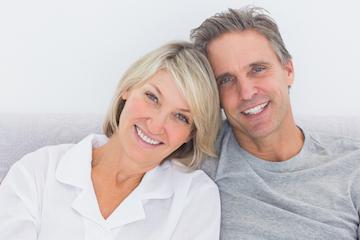 Couple smiling wearing dental implants near 70605