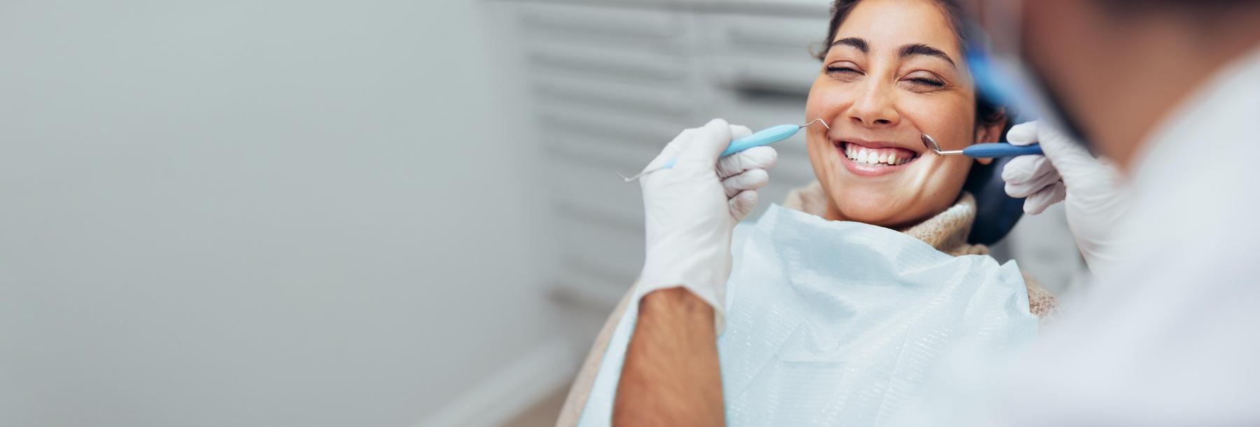 Woman smiling in treatment chair at dentist in Lake Charles LA